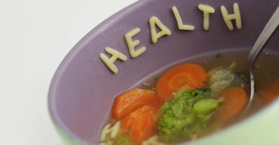 alphabet vegetable soup spelling out health on the bowl rim