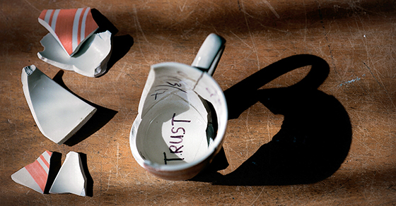 broken cup with the word trust written on the bottom