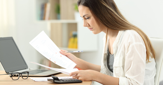 woman looking at financial paperwork