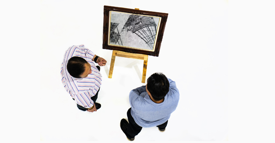 overhead view of two men looking at art