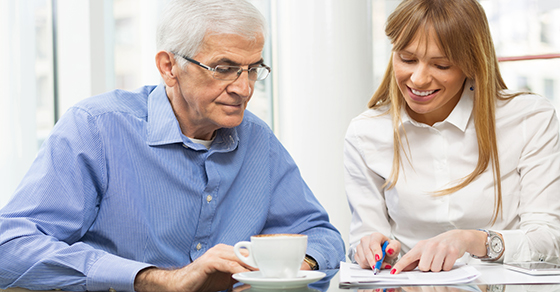 woman and older gentleman looking at paperwork