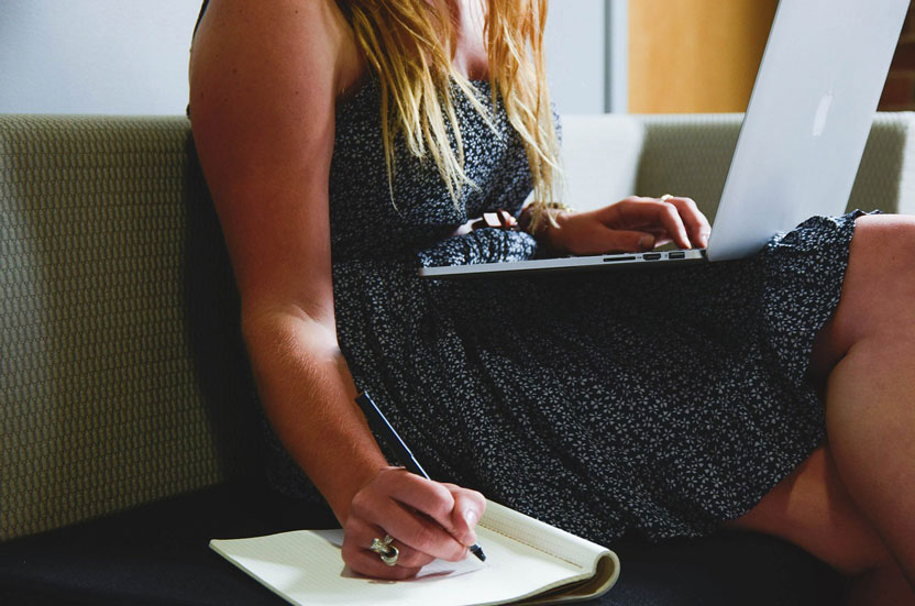 woman on laptop making list