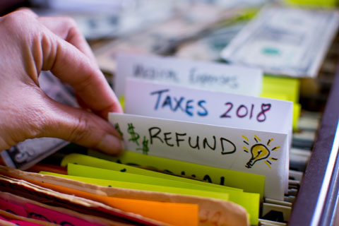 hand sorting through tax files