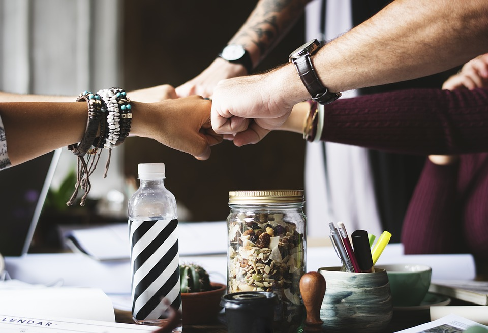 group of coworkers fistbumping