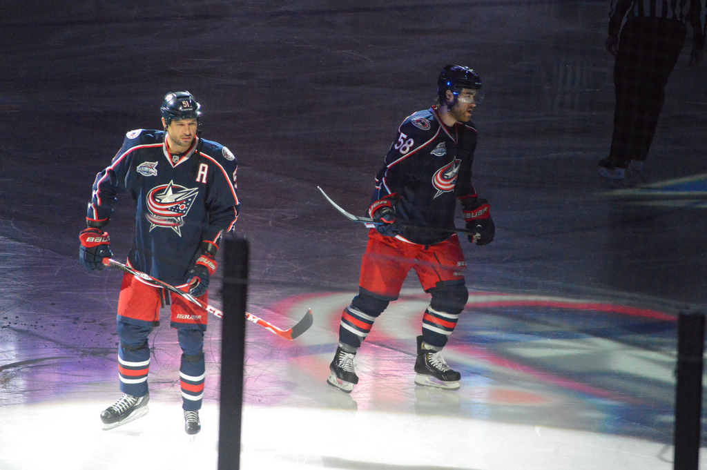two columbus blue jackets players skating