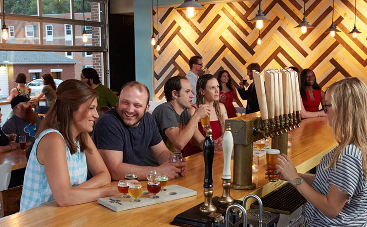 people inside lineage brewery