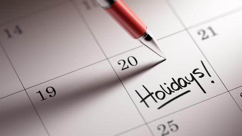 pen on a calendar that reads "holidays"