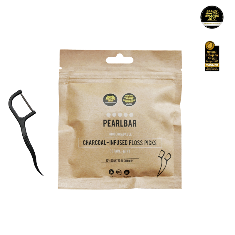 This is an image of a small, brown package of PearlBar charcoal-infused floss picks. A singular floss pick is also shown to the left side of the package.