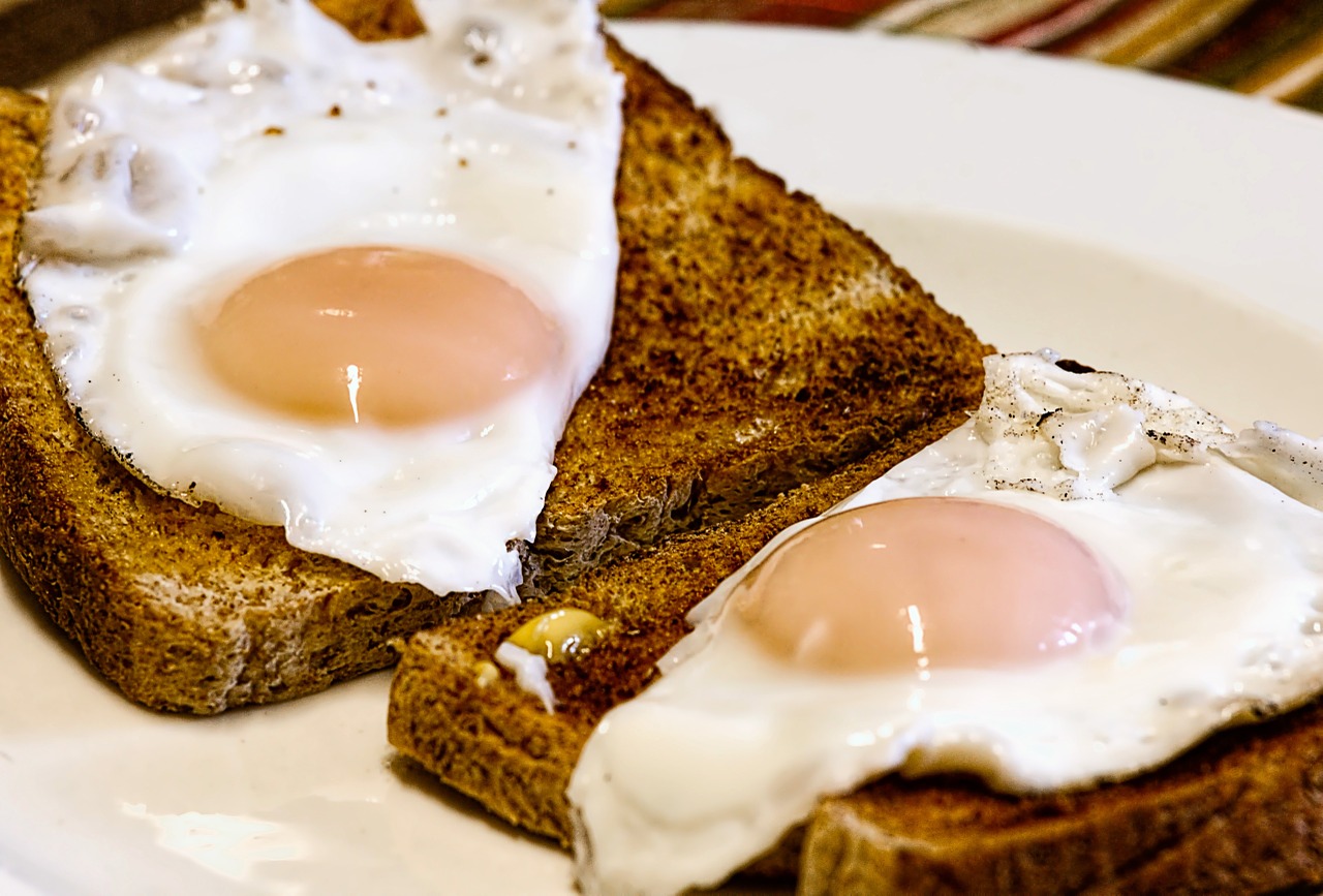 Sunny side up eggs on two pieces of toast