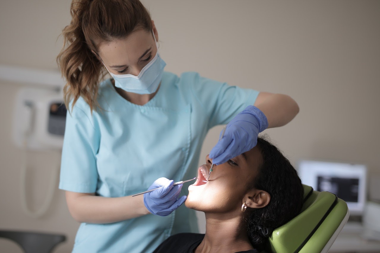 A woman has her teeth cleaned to keep her teeth and gums healthy and pain free.