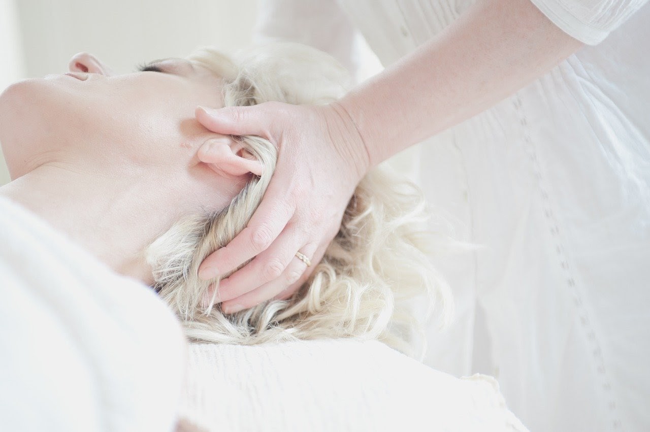 A woman getting a facial massage to target orofacial pain trigger points.