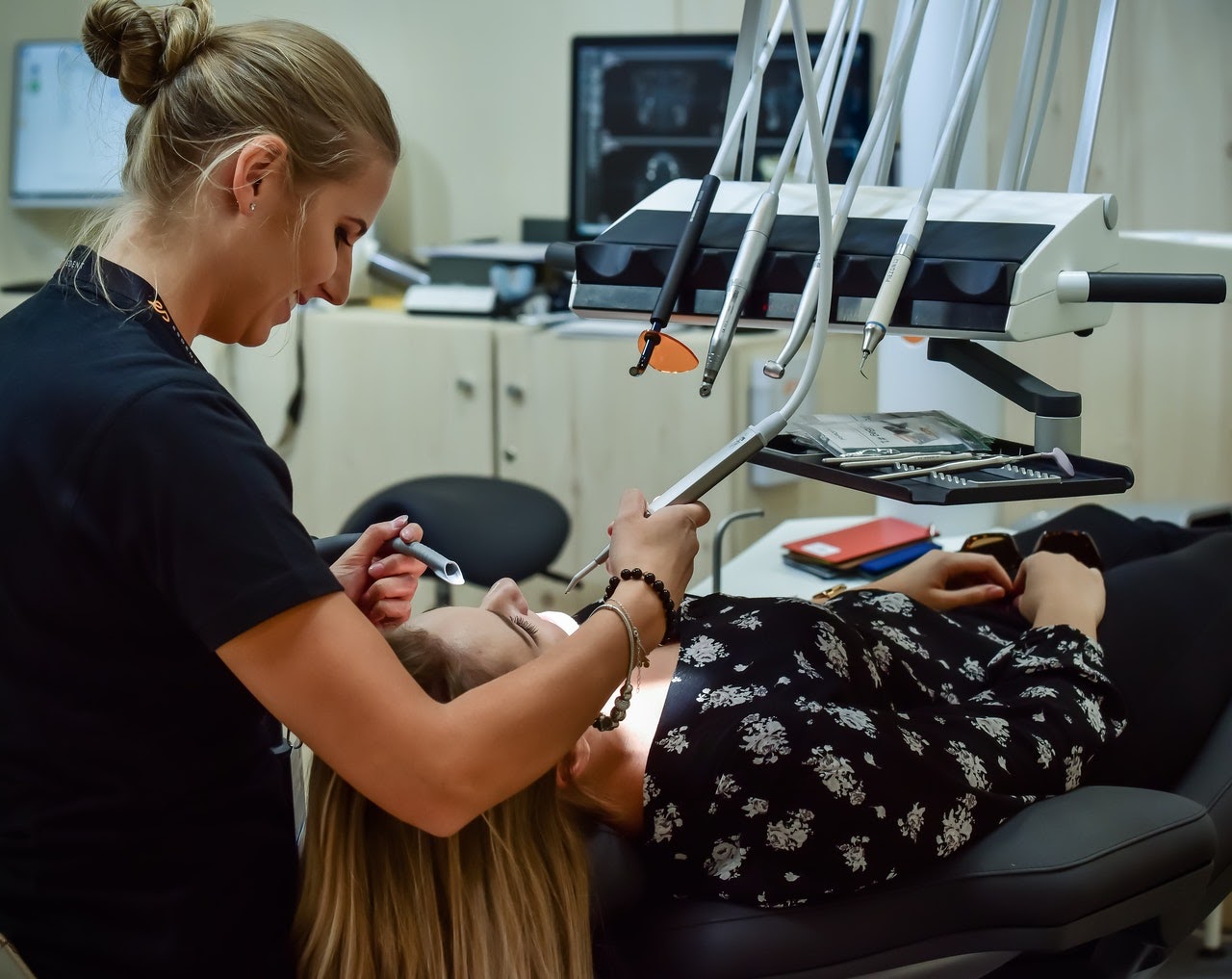 A woman talks to her dentist about her facial pain.
