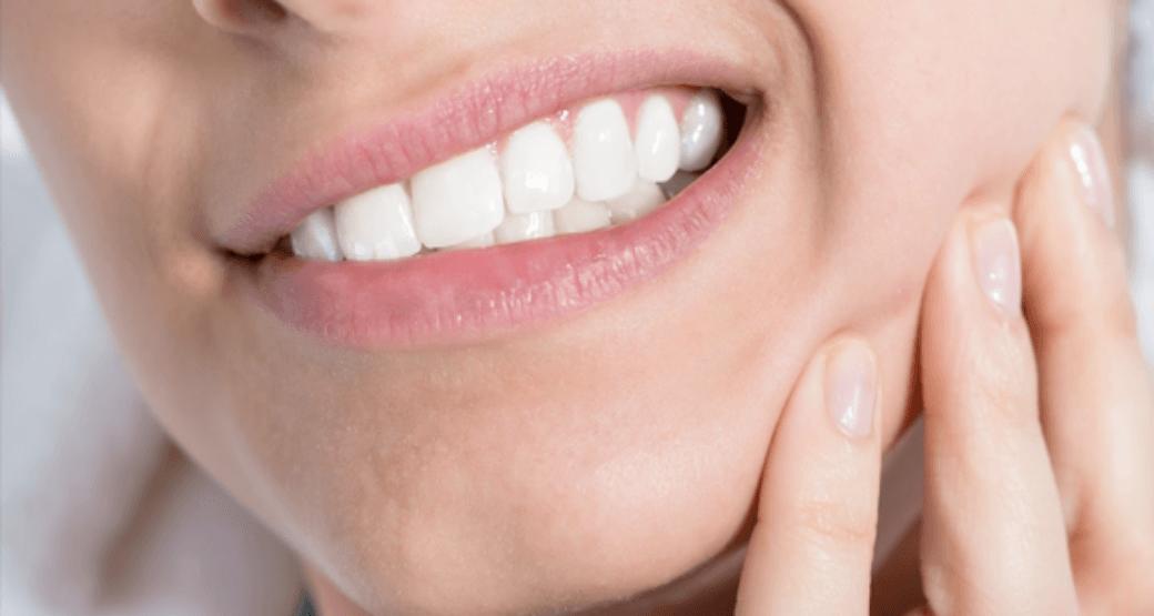 A close-up picture of someone clenching their teeth.