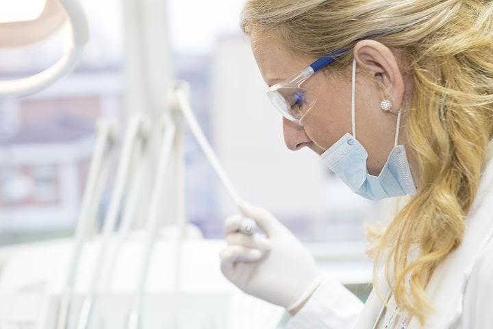a dentist getting ready to do an exam, they can help you with bruxism