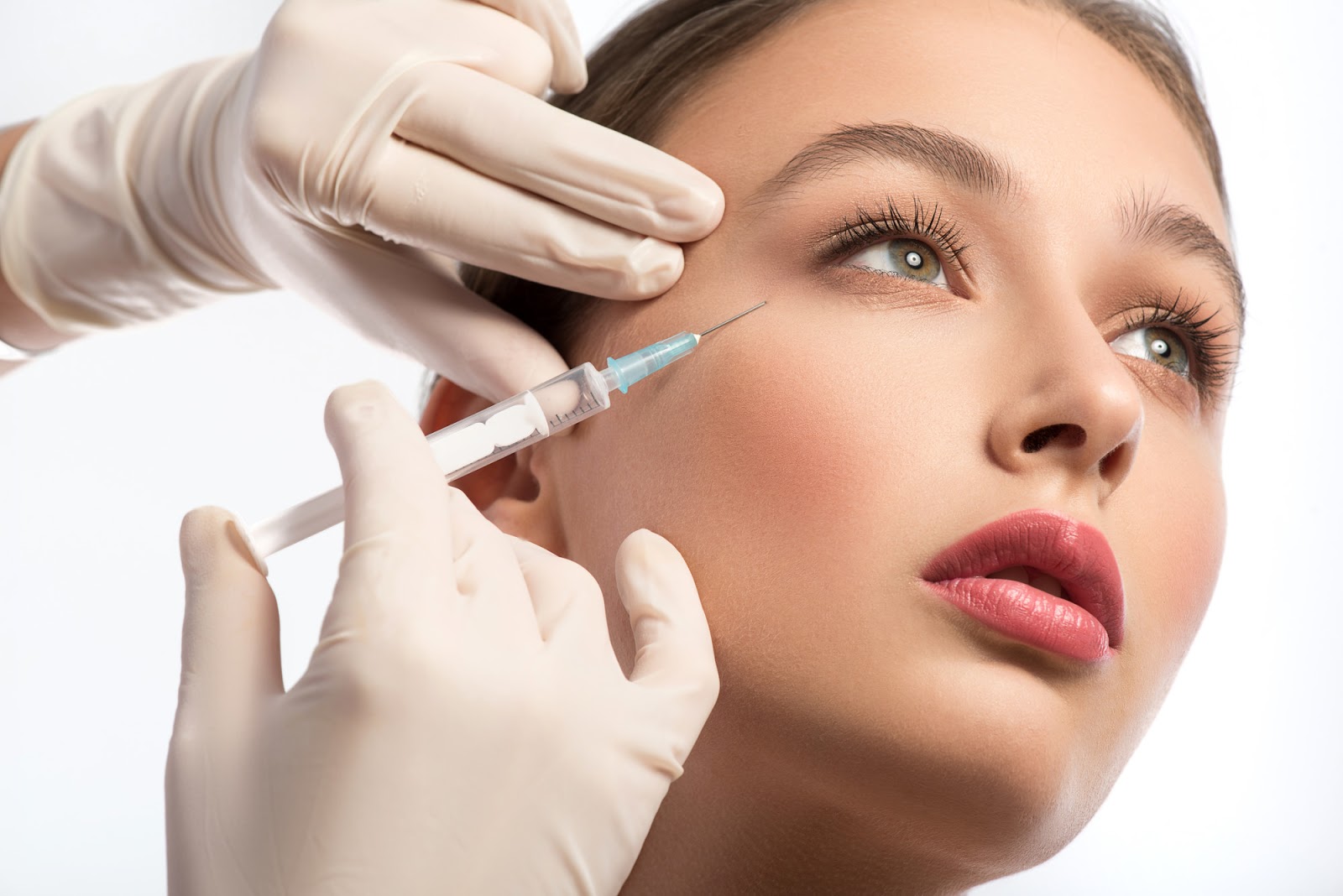 woman receiving botox injections underneath her eyes