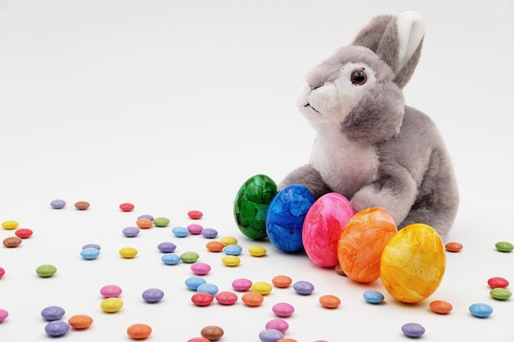 a cute stuffed animal Easter bunny surrounded by candy