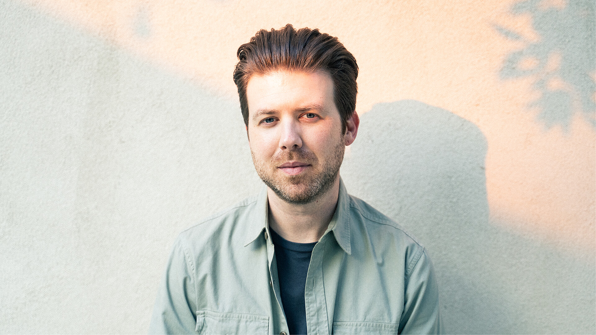 Photo of illustrator, designer and animator, Greg Gunn, in his studio