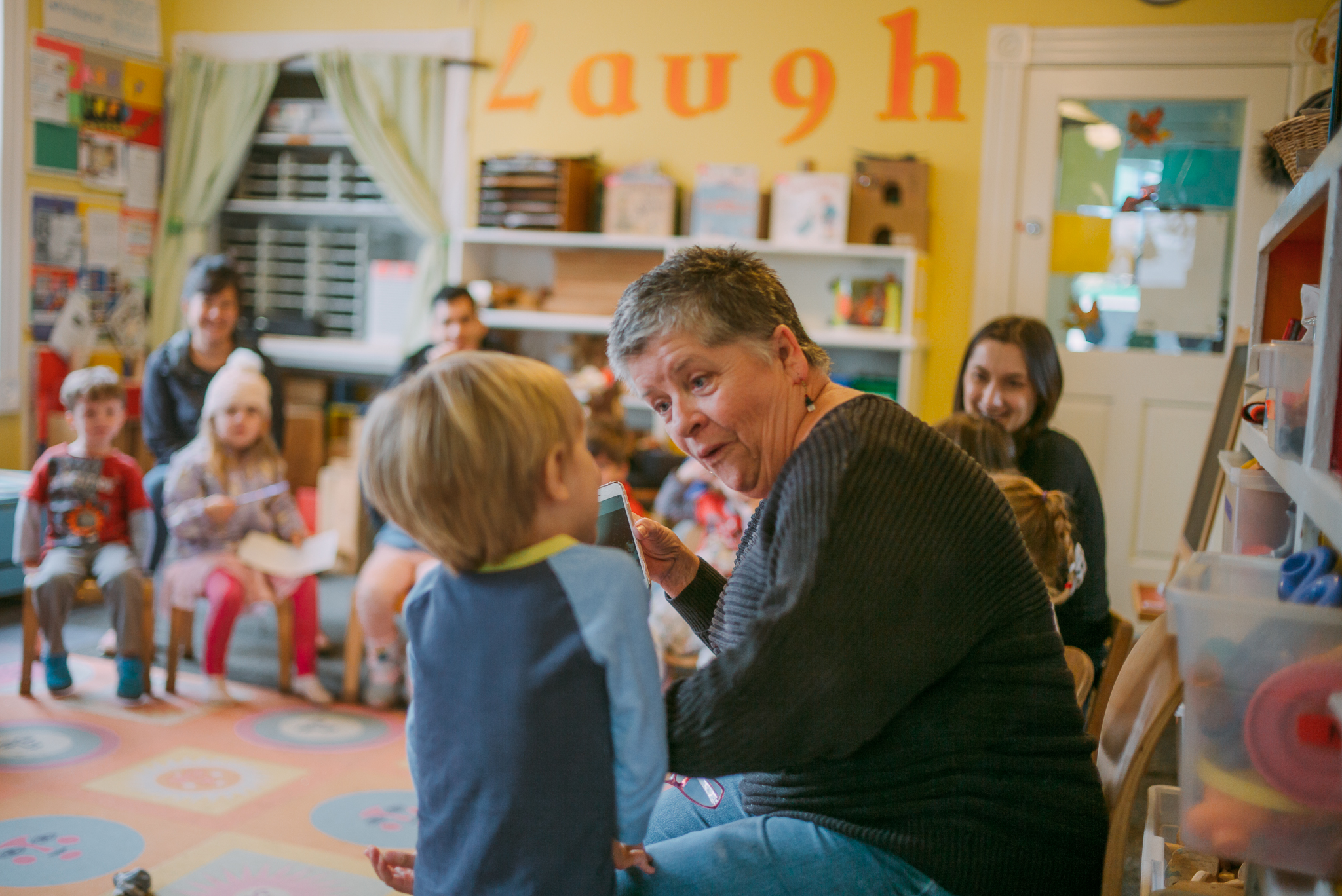 Teacher Pammi interacts with a student during show and tell at the Cottage.