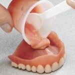 Putty being poured into a denture