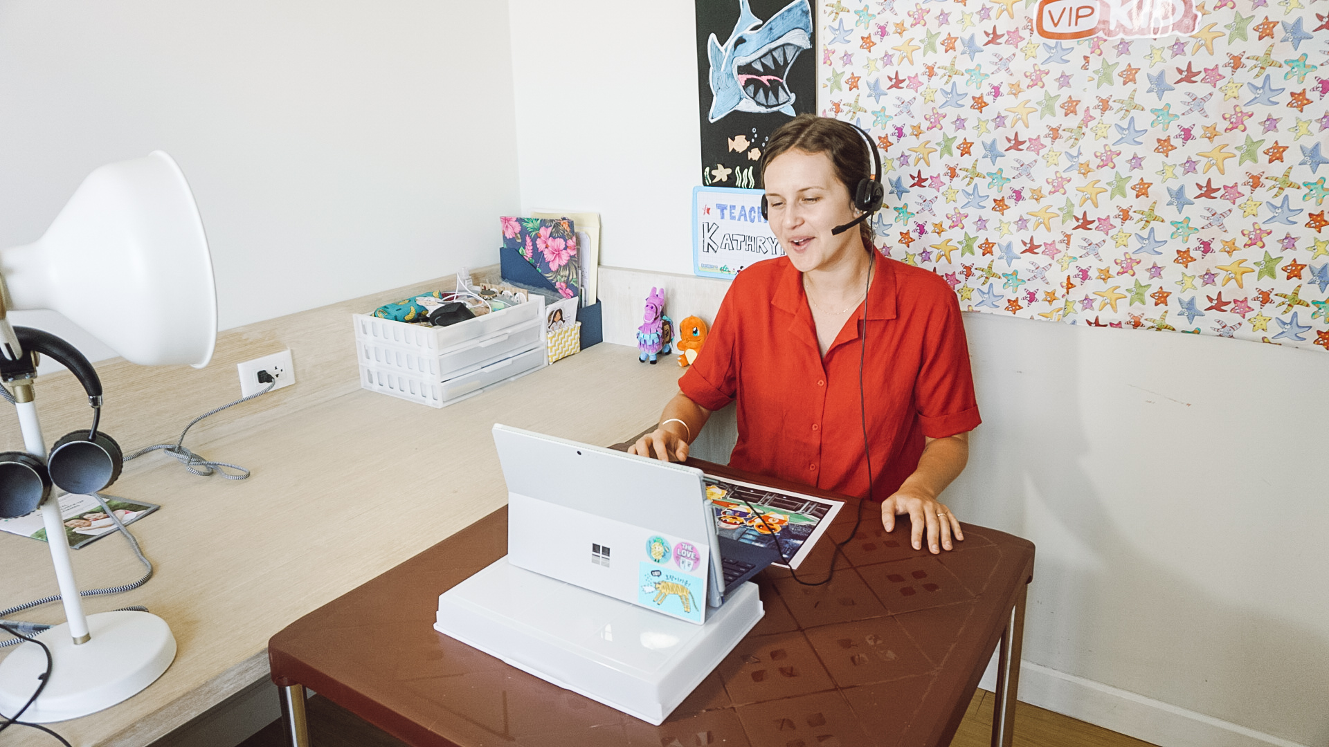 A teacher in her classroom teaching English online with VIPKID