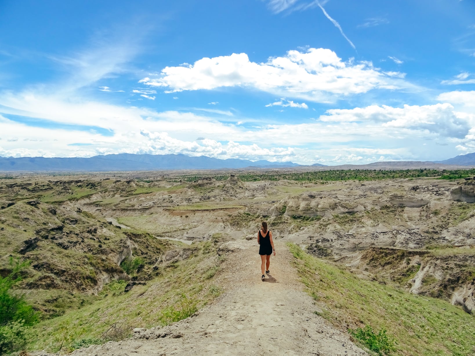 Woman exploring low mountains on a beautiful, sunny day