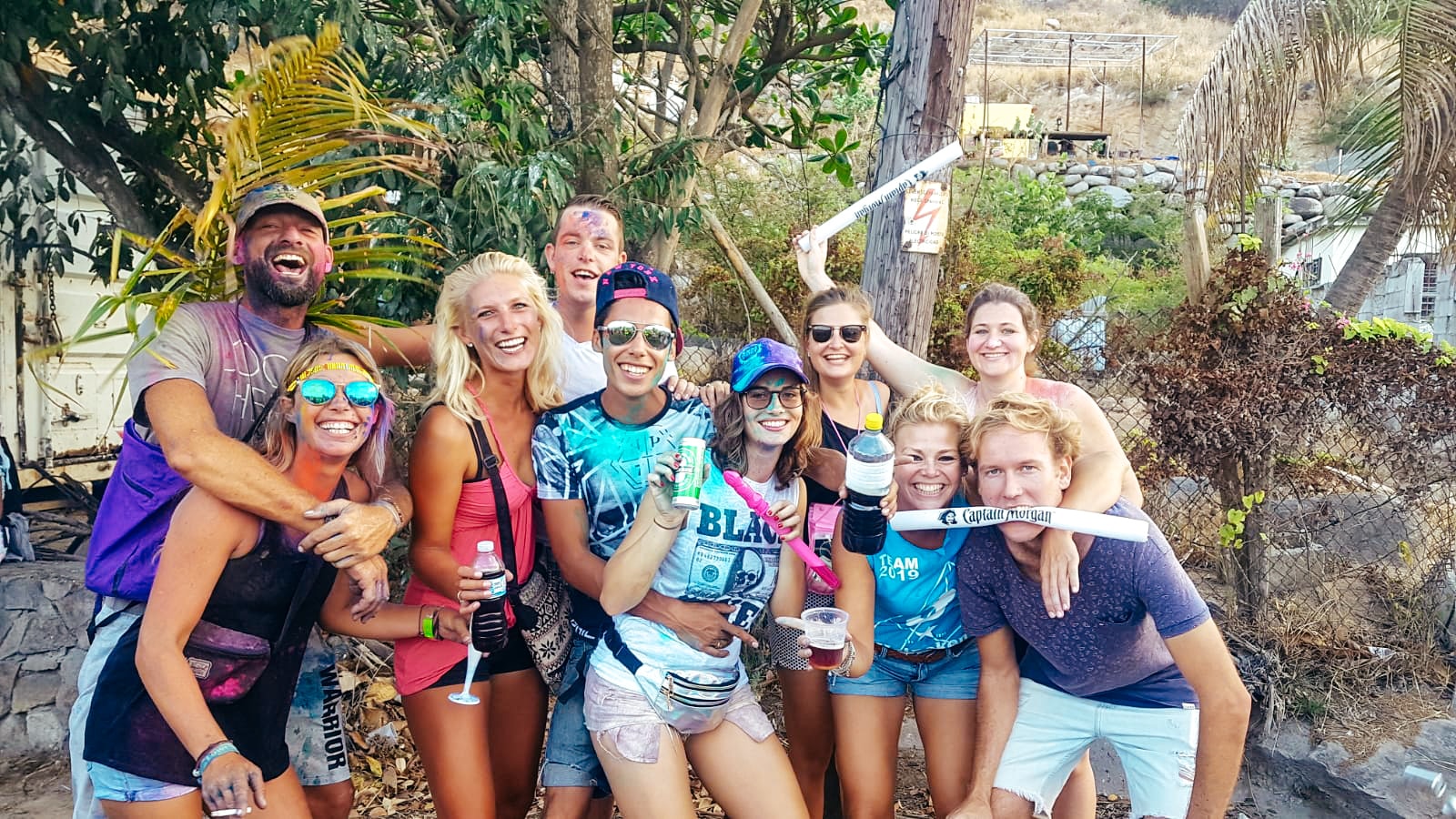 A group of friends splattered in paint having a fun day on Sint Maarten island