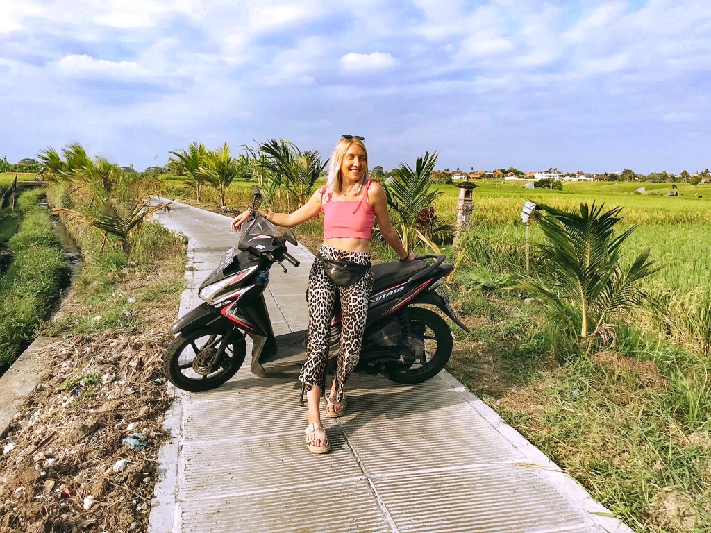 An expat woman posing with her motorbike in Bali