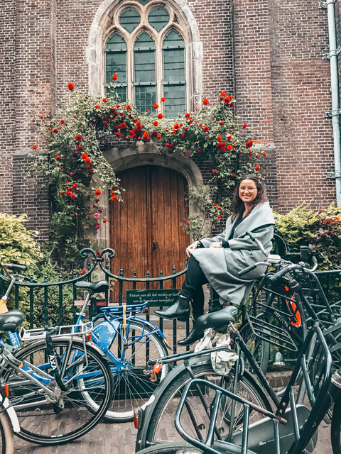 A woman in Amsterdam sitting on a bike