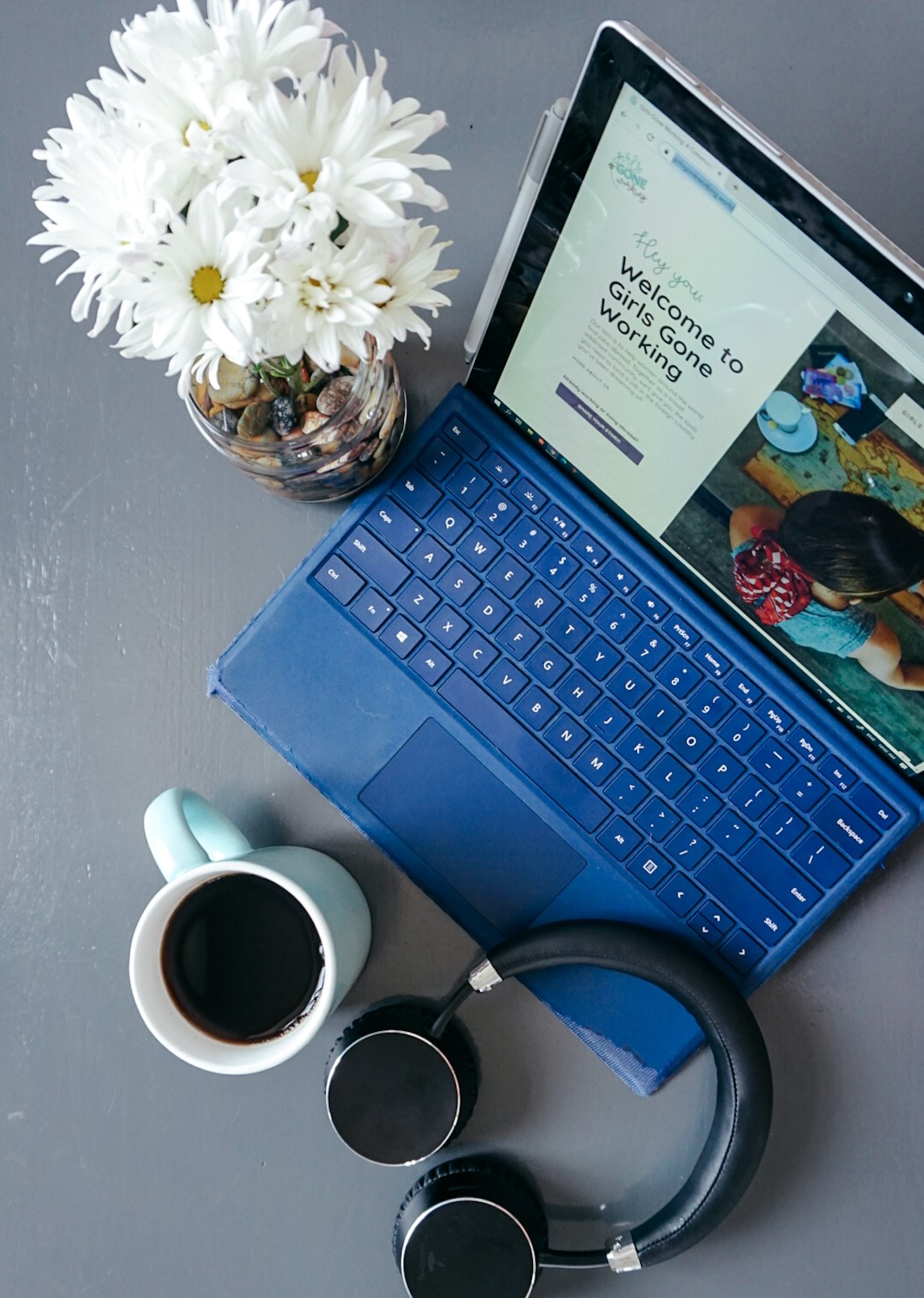 flatlay image of flowers, laptop, headphones and coffee- the basics to starting your online career!