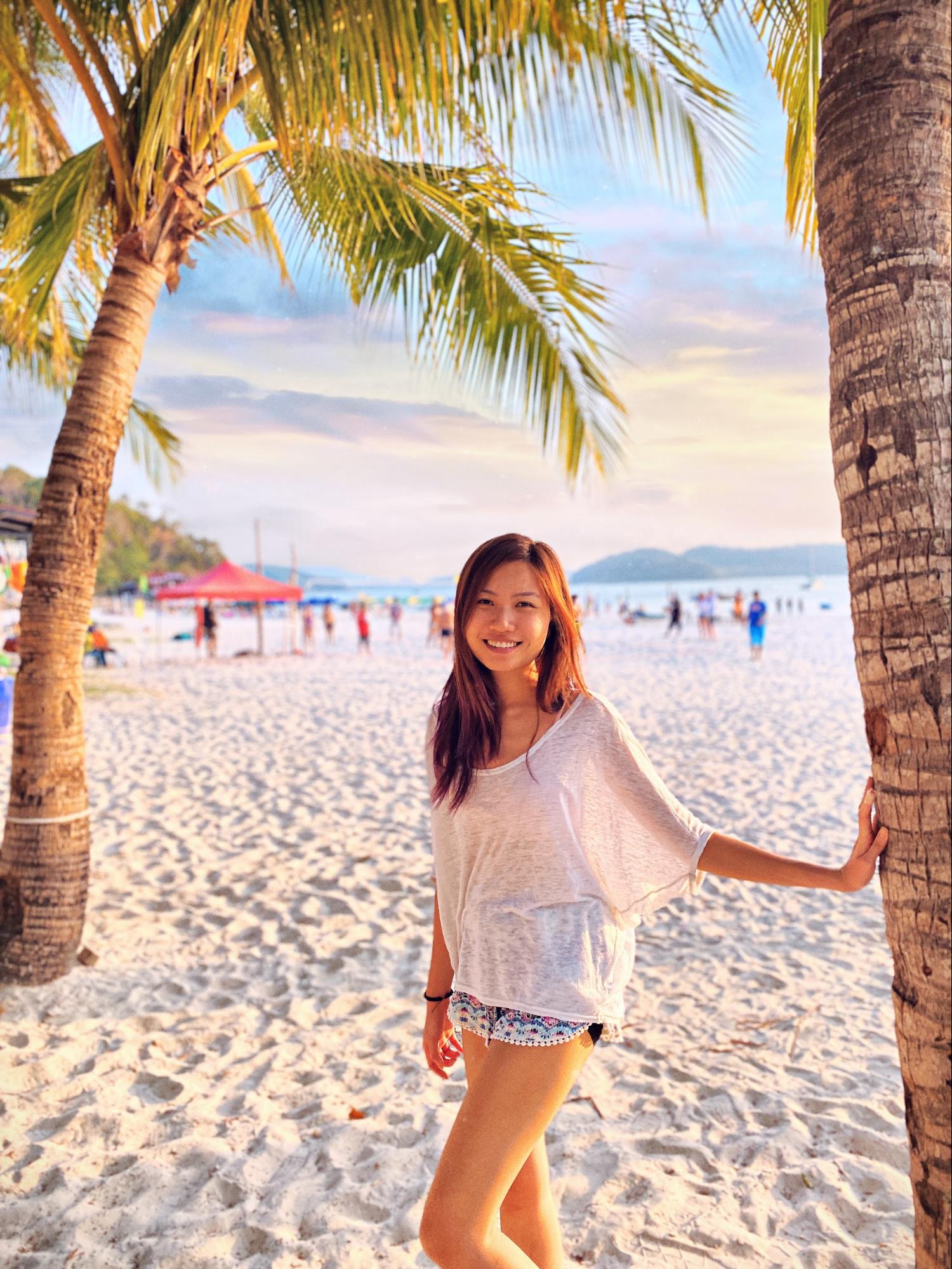 female digital nomad enjoying free time on the beach at sunset