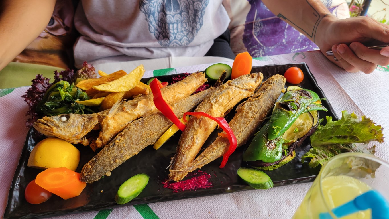 a plate of freshly fried fish and veggies