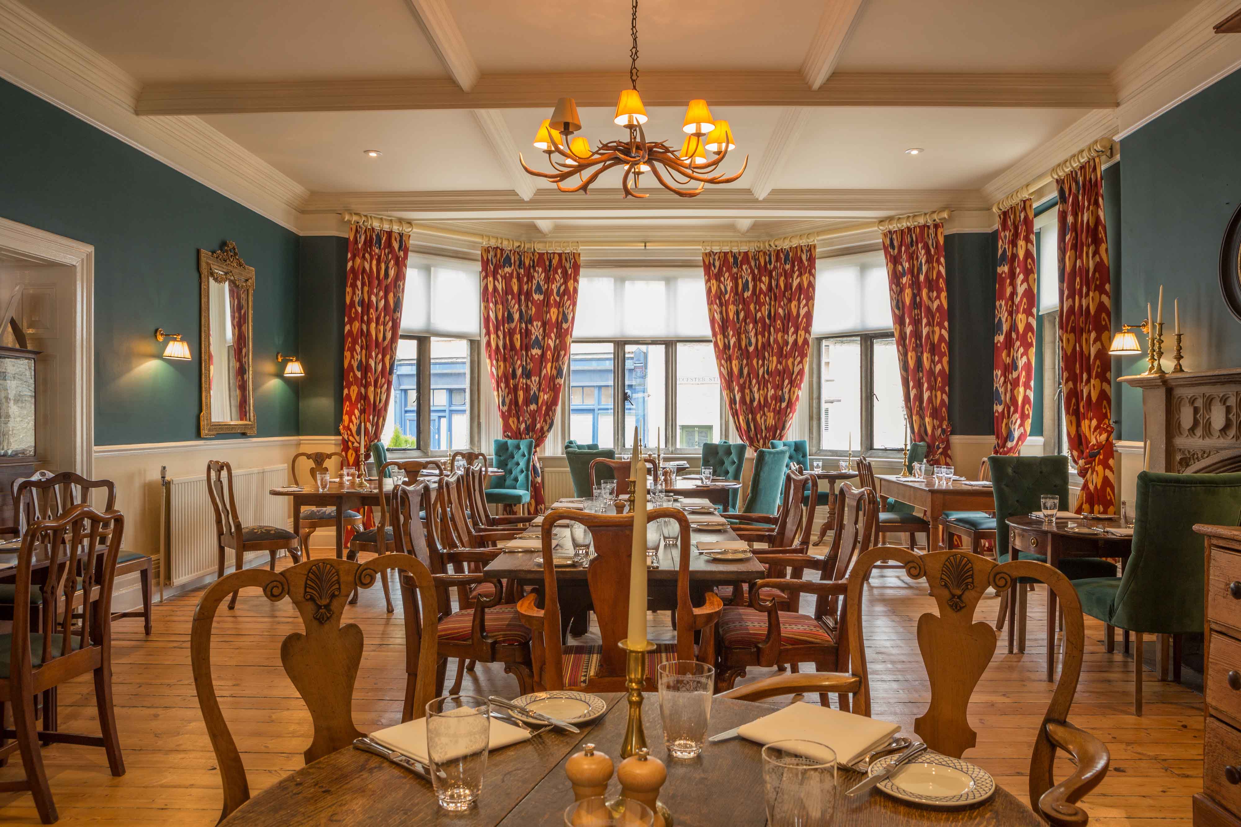 The luxurious interior of the hotel's dining room with blue walls and elegant furnishings.