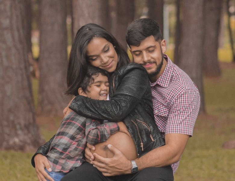 Child, woman, man holding pregancy bump