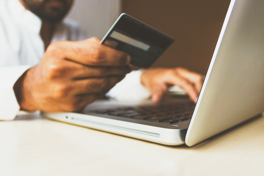 man uses his credit card online