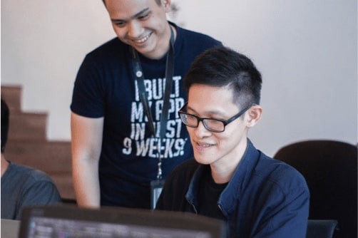 a mentor helping student coding