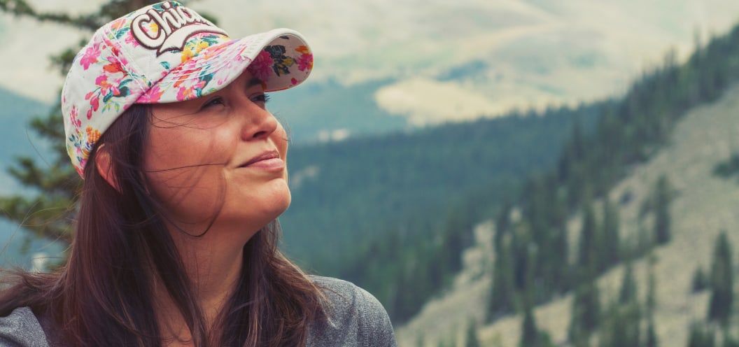 woman looking happy in the mountains