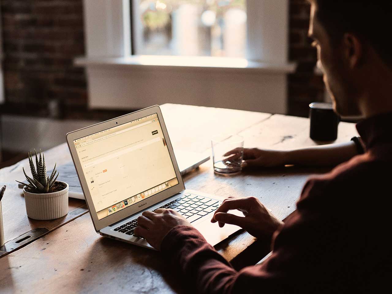 man uses his laptop for work