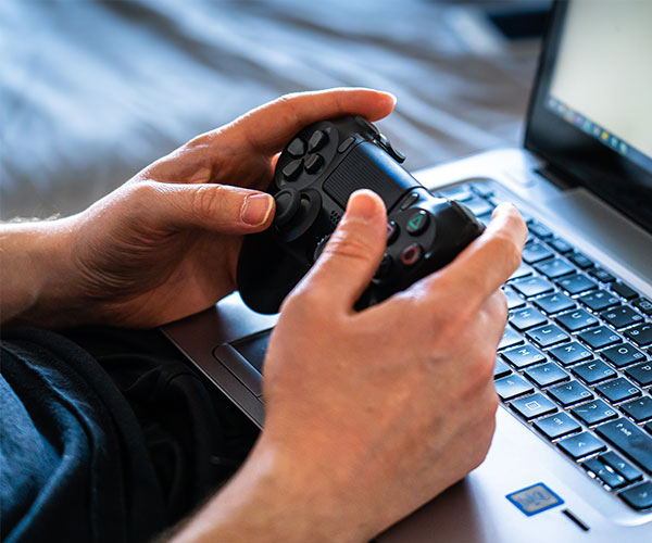 person-holding-black-game-controller