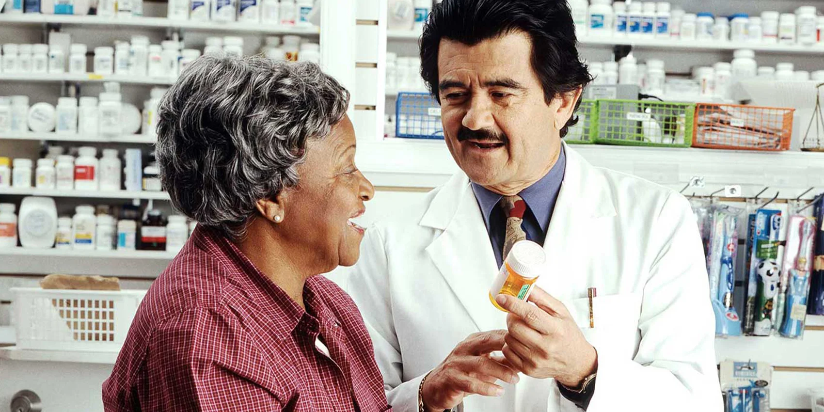 Picture of a doctor holding a medicine and an elderly woman