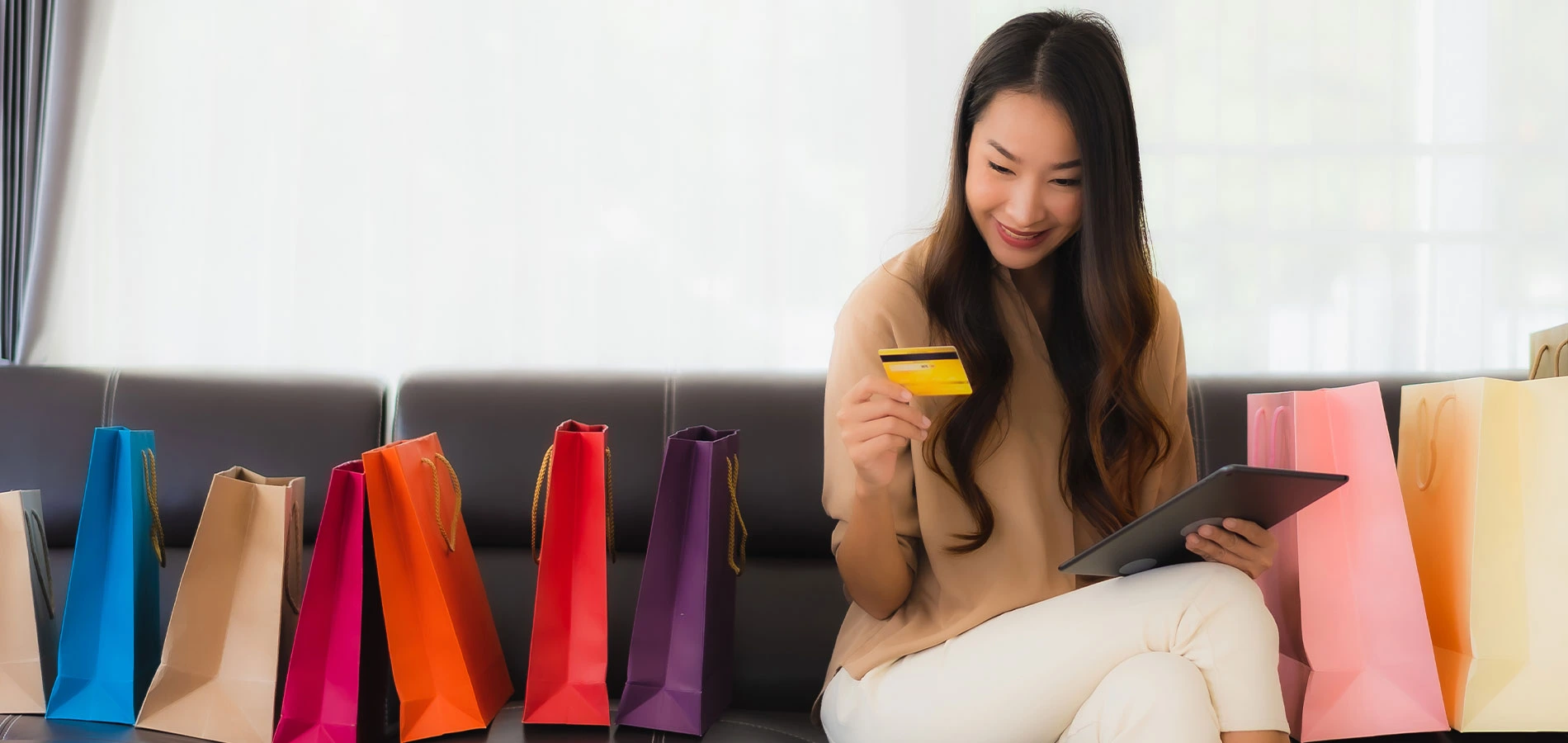 Happy shop owner holding a credit card