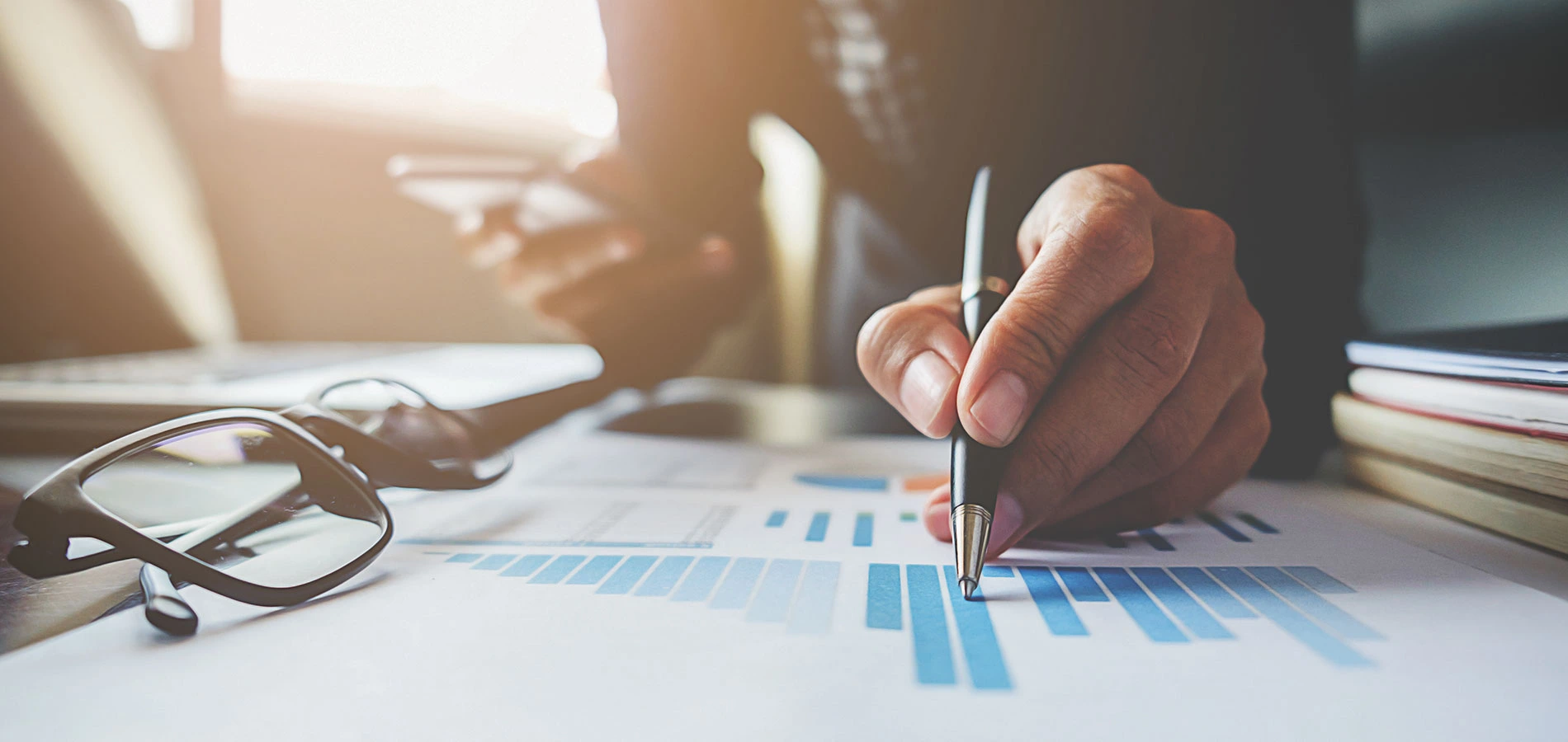 Pen pointing in a graph printed in a paper