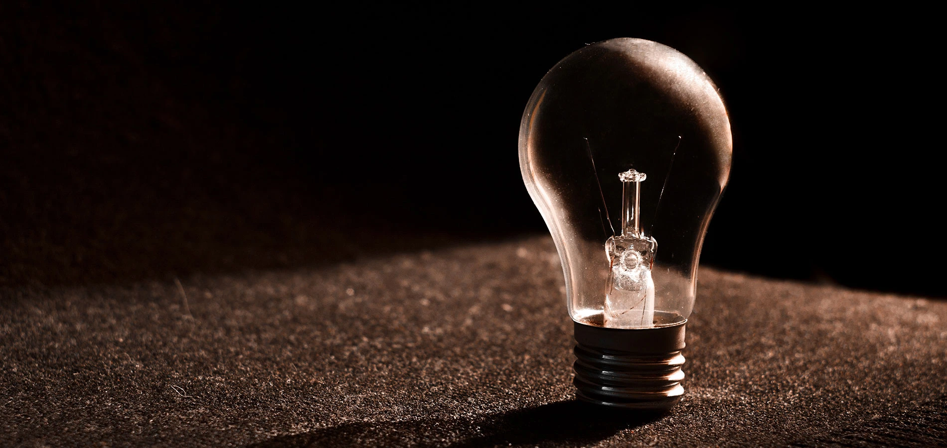 Close up photo of a light bulb in the dark