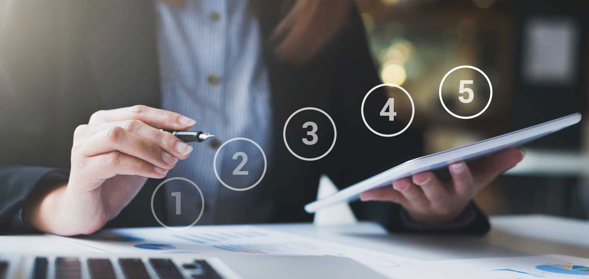 Woman holding a tablet and pen device with numbers one to five graphic