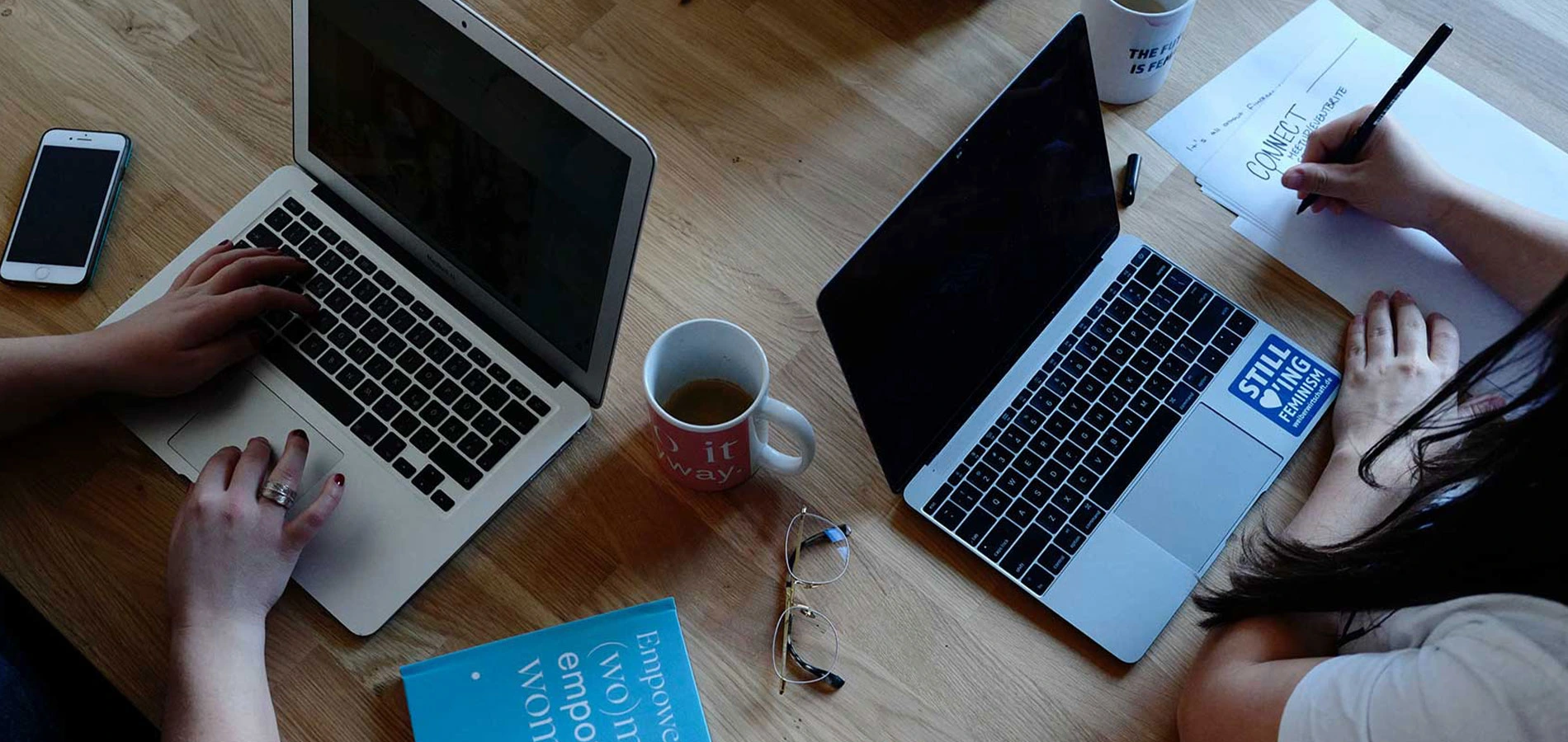Two people working using their laptop