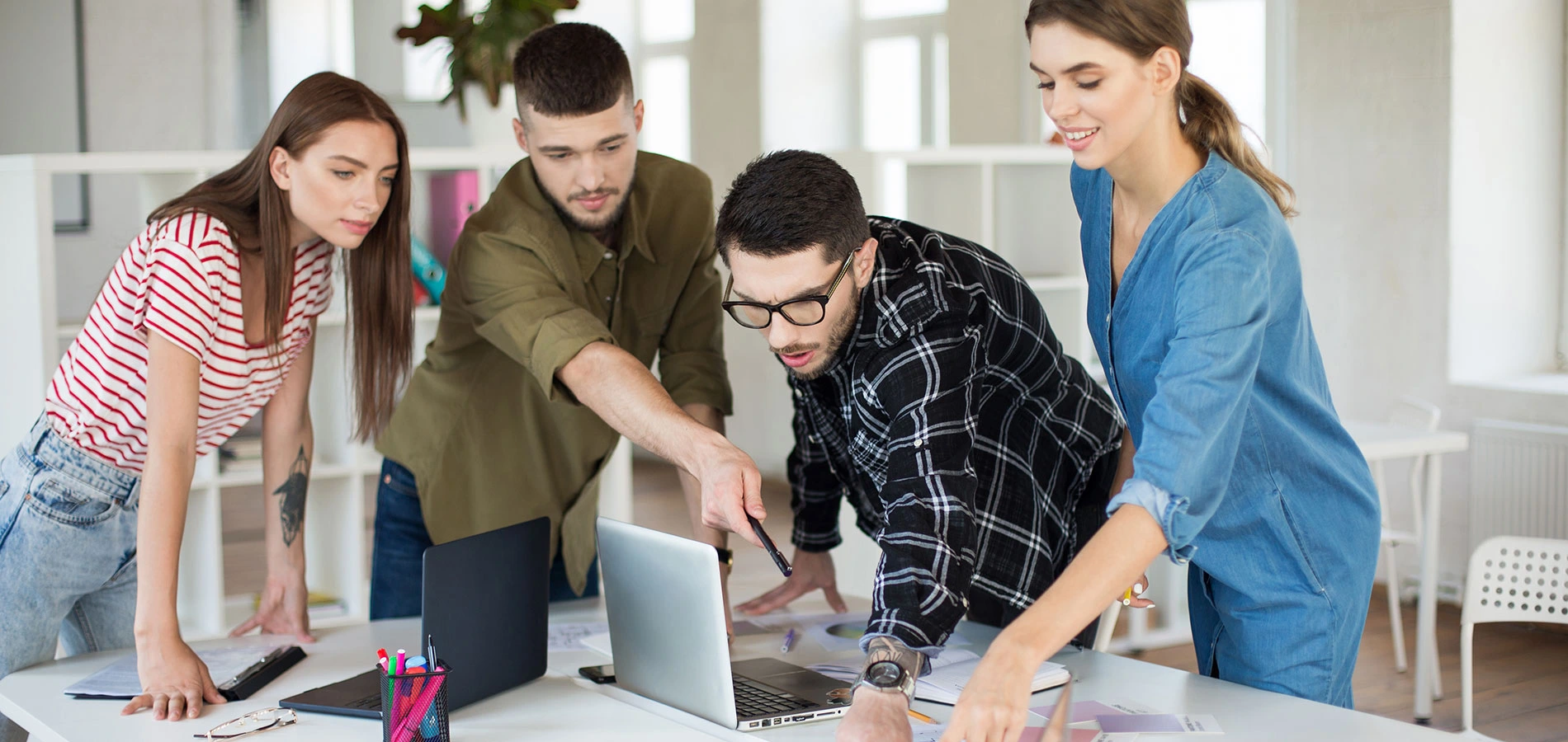 Young creative people discussing new project together