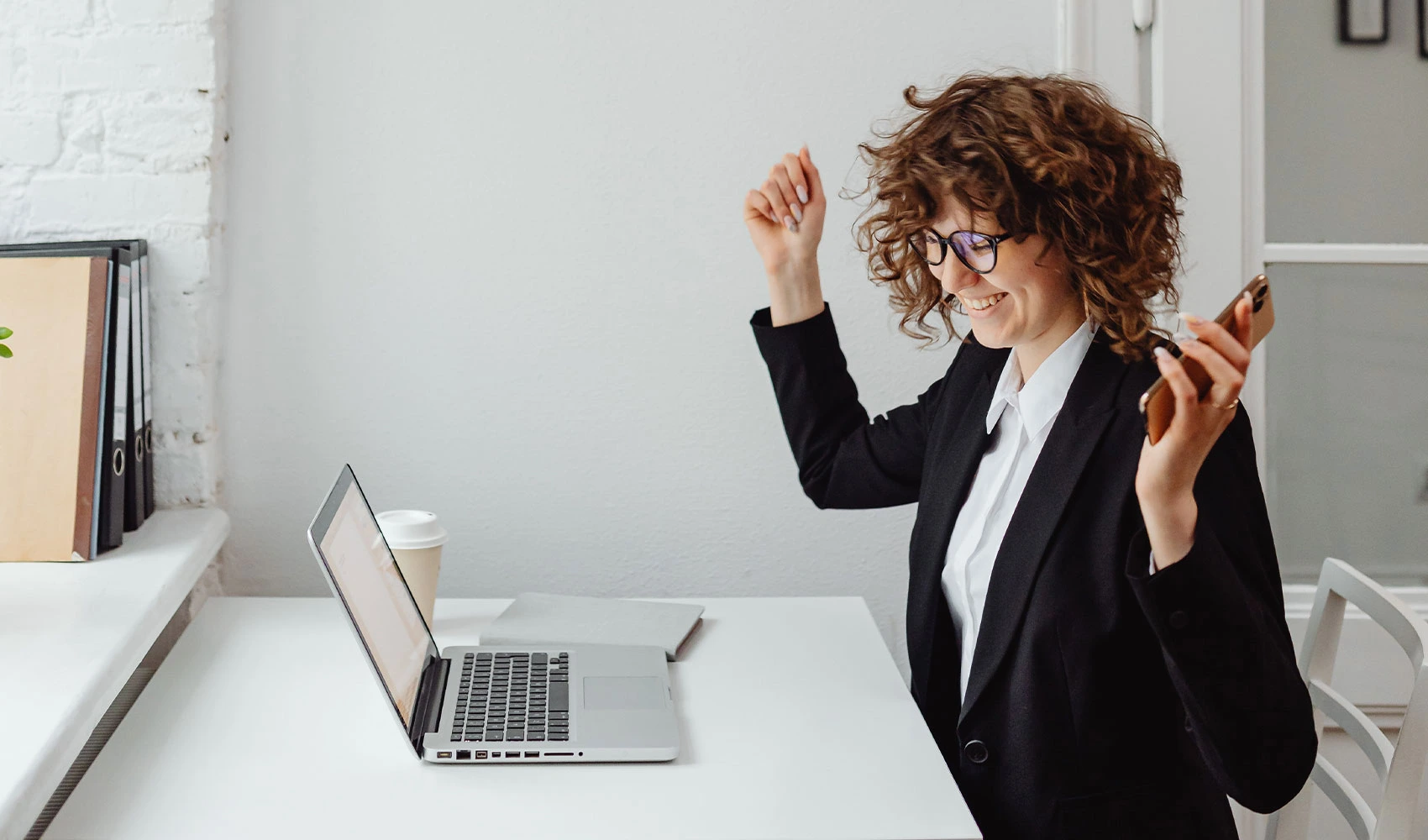 A woman in black blazer sitting in front of the table