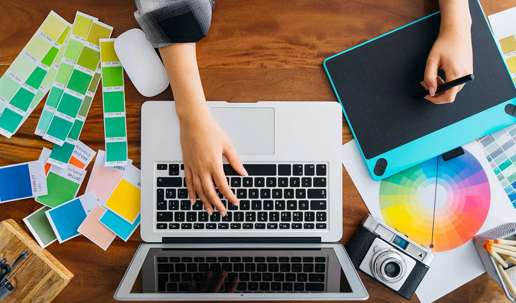 Woman drawing using laptop and a pen tab