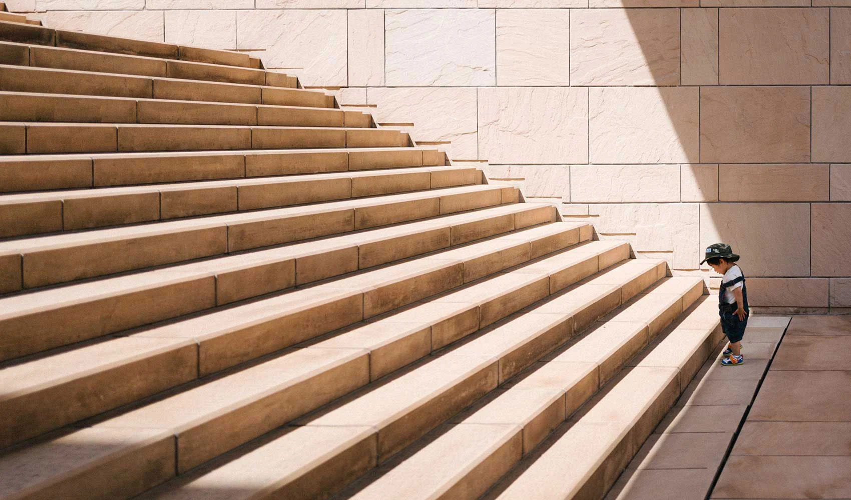 Kid in-front of a large stairs