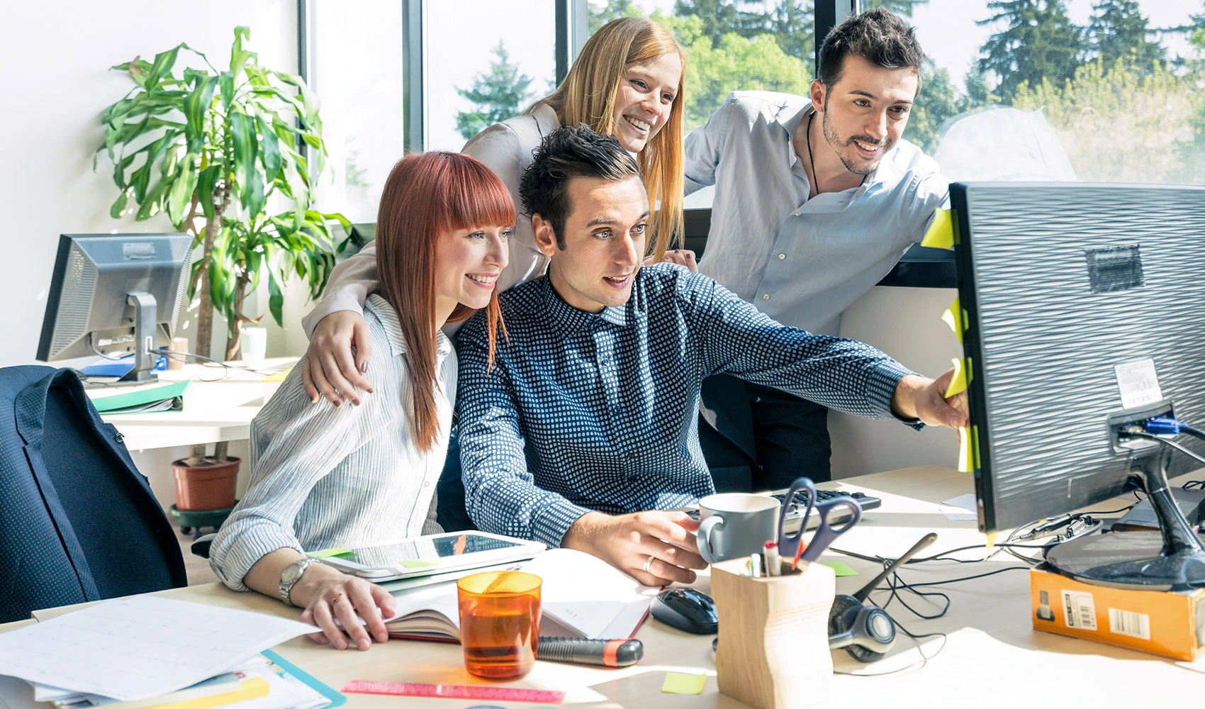 Happy employees using computer
