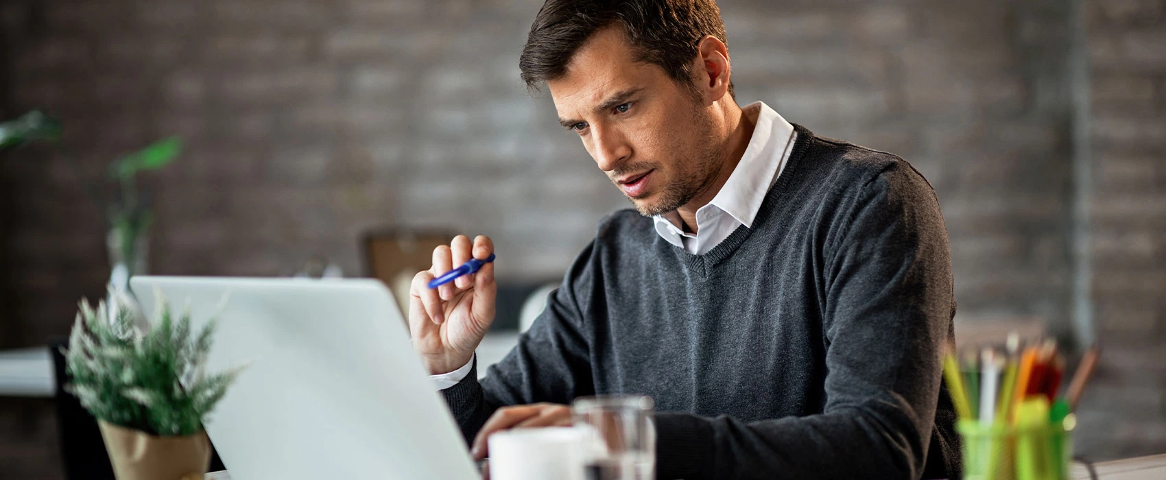 Focused man working with a laptop